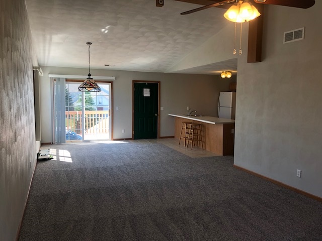 10149 Monarch Road, Unit 4 Roscoe, IL 61073 - Photo 7 of 21 a view of an empty room with window and chandelier fan