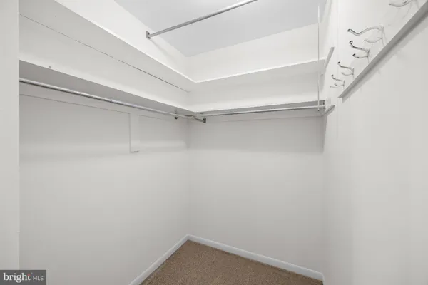 a bathroom with a granite countertop sink a mirror and a toilet