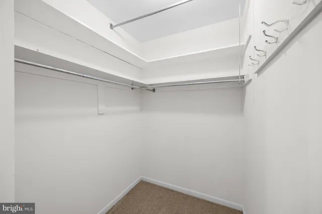 a bathroom with a granite countertop sink a mirror and a toilet