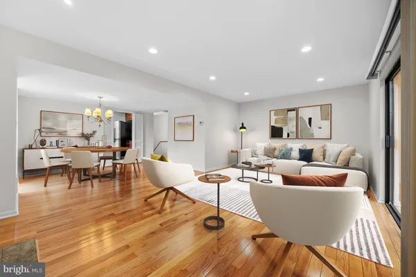 a living room with furniture a rug and a chandelier