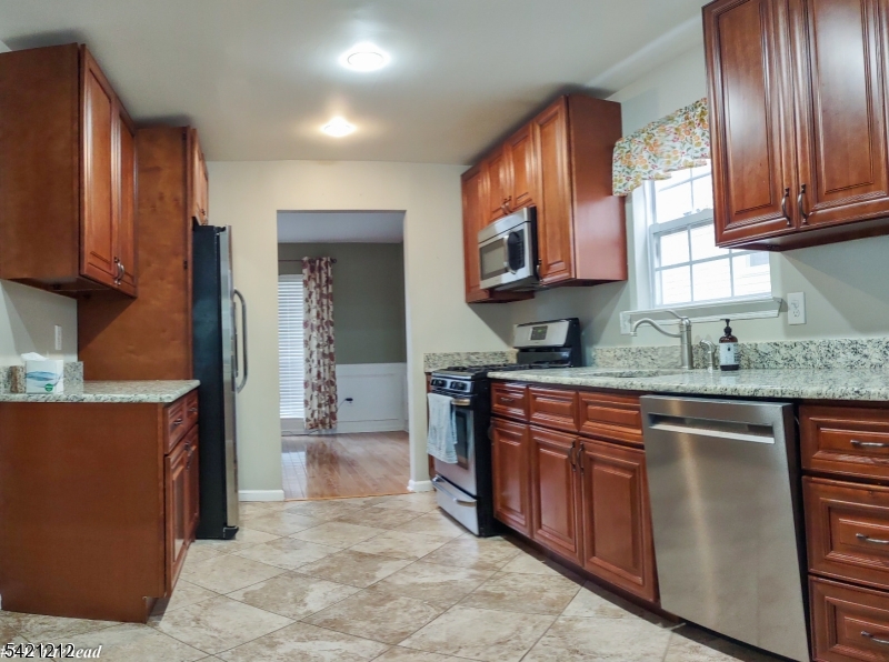 6 Whitehead Road Bridgewater, NJ 08807 - Photo 3 of 14 a kitchen with stainless steel appliances granite countertop a stove a sink and a microwave