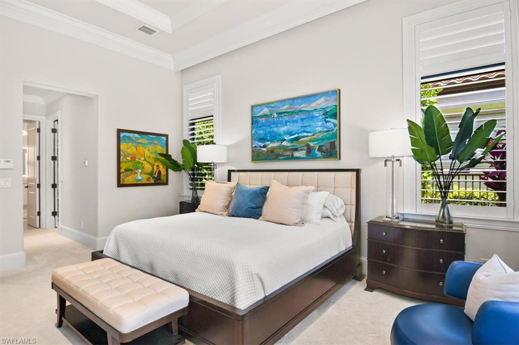 2220 Residence Circle Naples, FL 34105 - Photo 19 of 50 a bedroom with a bed and wooden floor