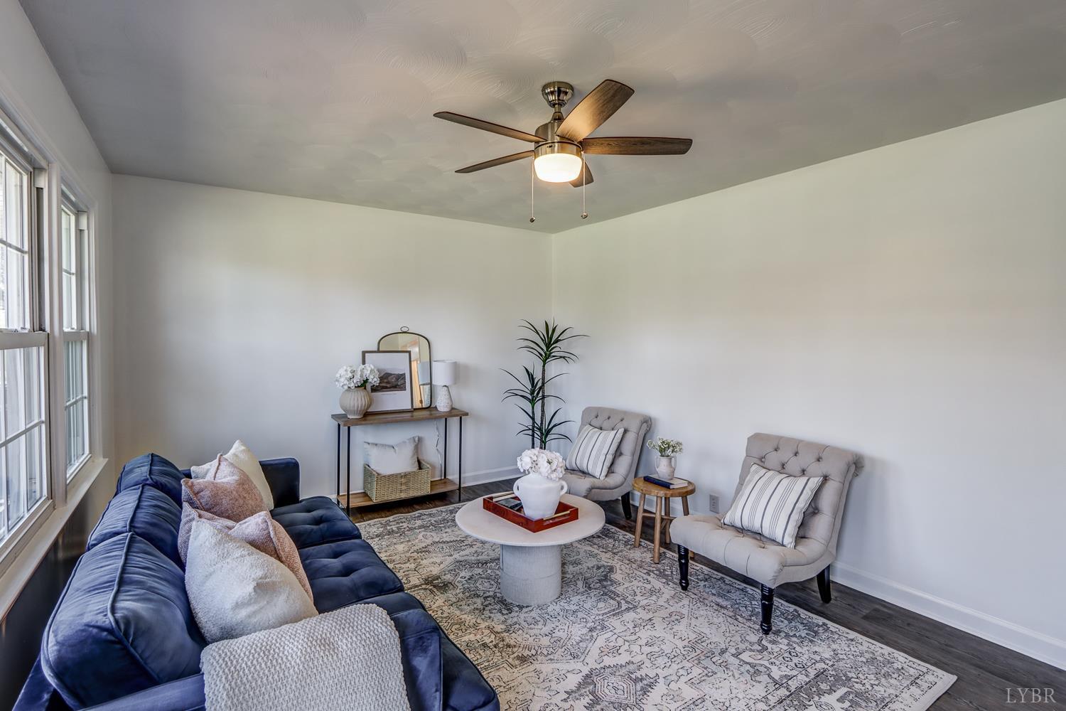 303 Grove Street Hurt, VA 24563 - Photo 11 of 51 a living room with furniture and a chandelier