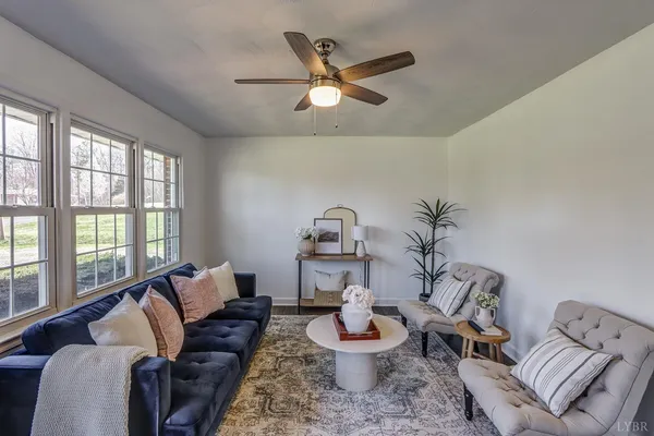 a kitchen with a dining table chairs and white cabinets