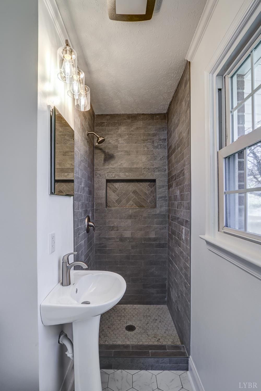 303 Grove Street Hurt, VA 24563 - Photo 31 of 51 a bathroom with a sink a mirror and shower