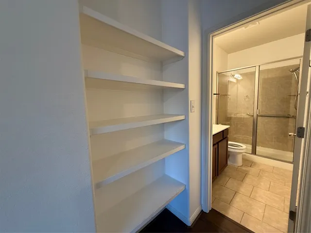 a bathroom with a sink toilet a mirror and shower