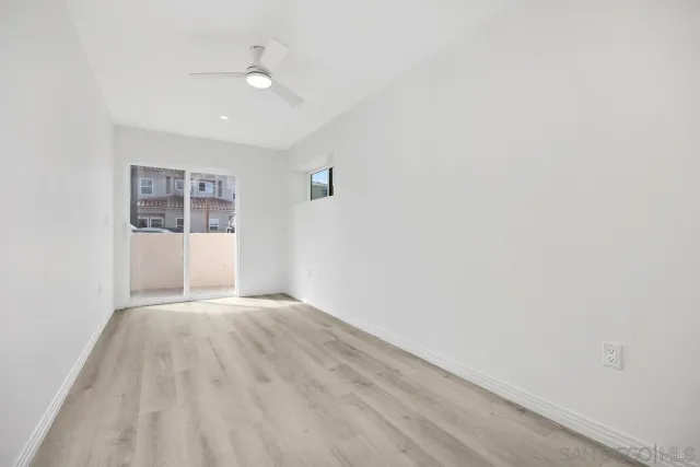 a view of wooden floor and windows in a room