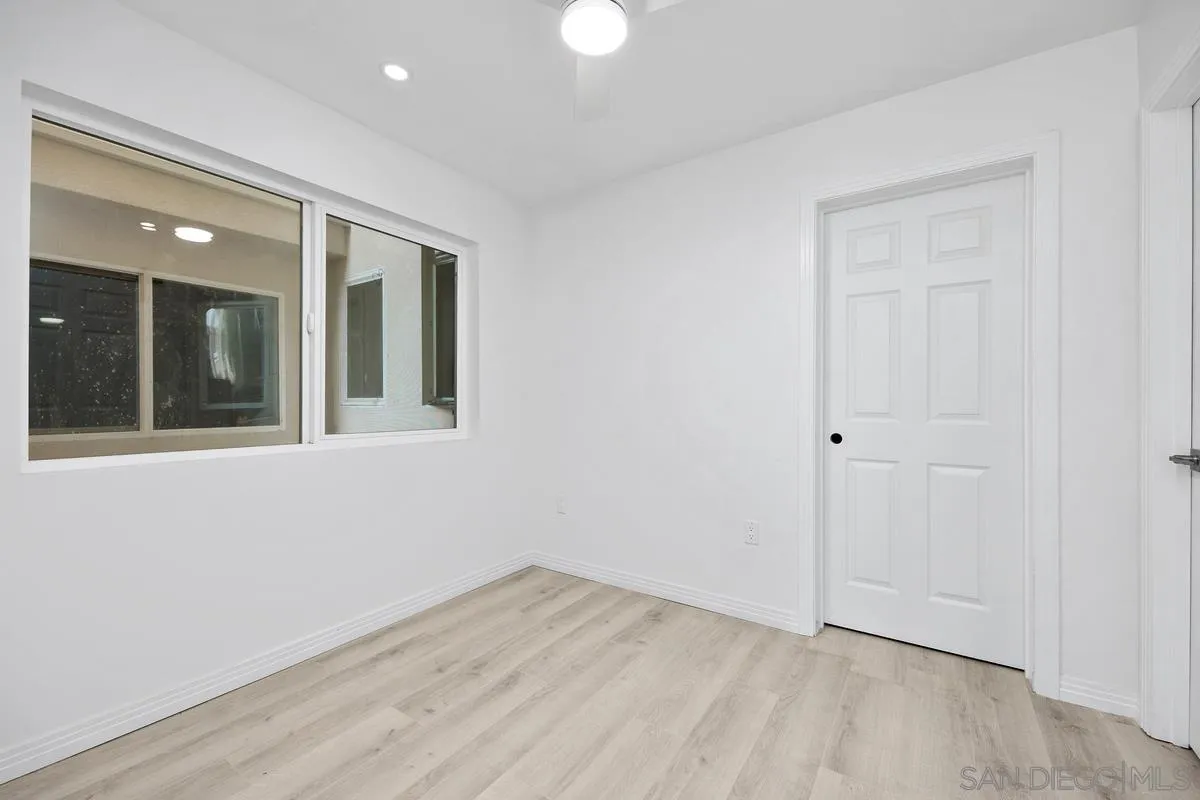 2157 Manchester Avenue Cardiff, CA 92007 - Photo 30 of 35 an empty room with wooden floor and windows