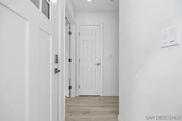 a view of a hallway with wooden floor