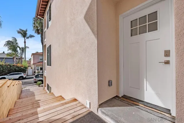 a view of a balcony with wooden floor and a potted plant
