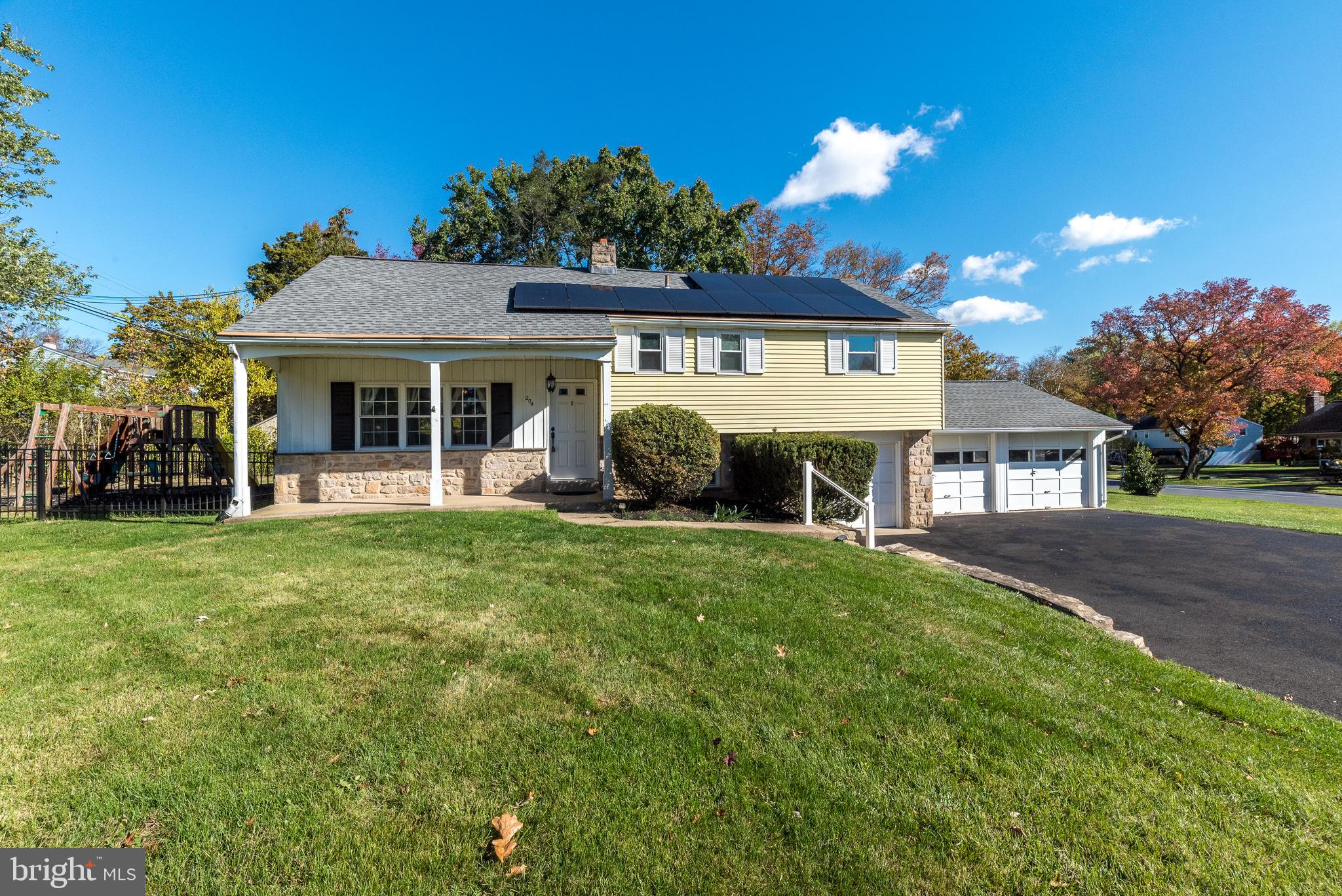 a front view of a house with a garden and plants