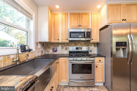 a kitchen with a stove a sink and a refrigerator