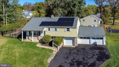 a house that has a tree in front of the house