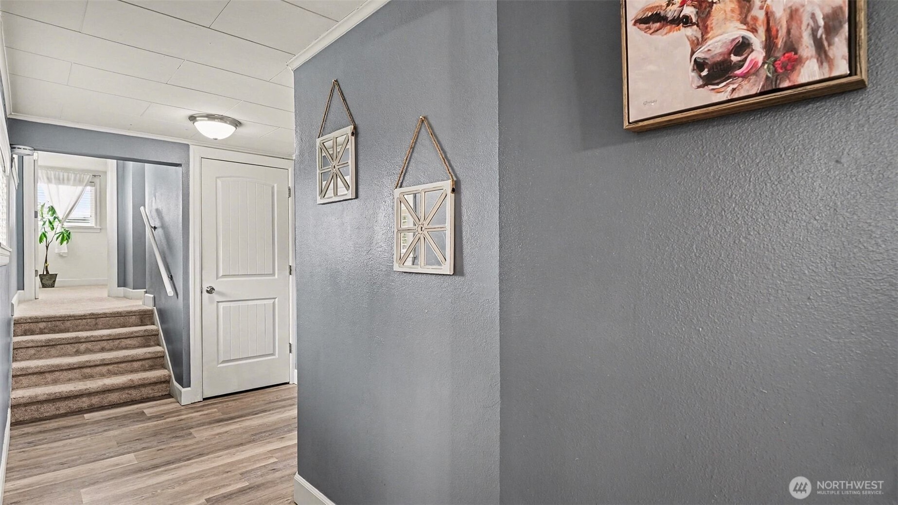 544 Simons Road Monroe, WA 98272 - Photo 13 of 34 a view of a hallway with paintings on the wall