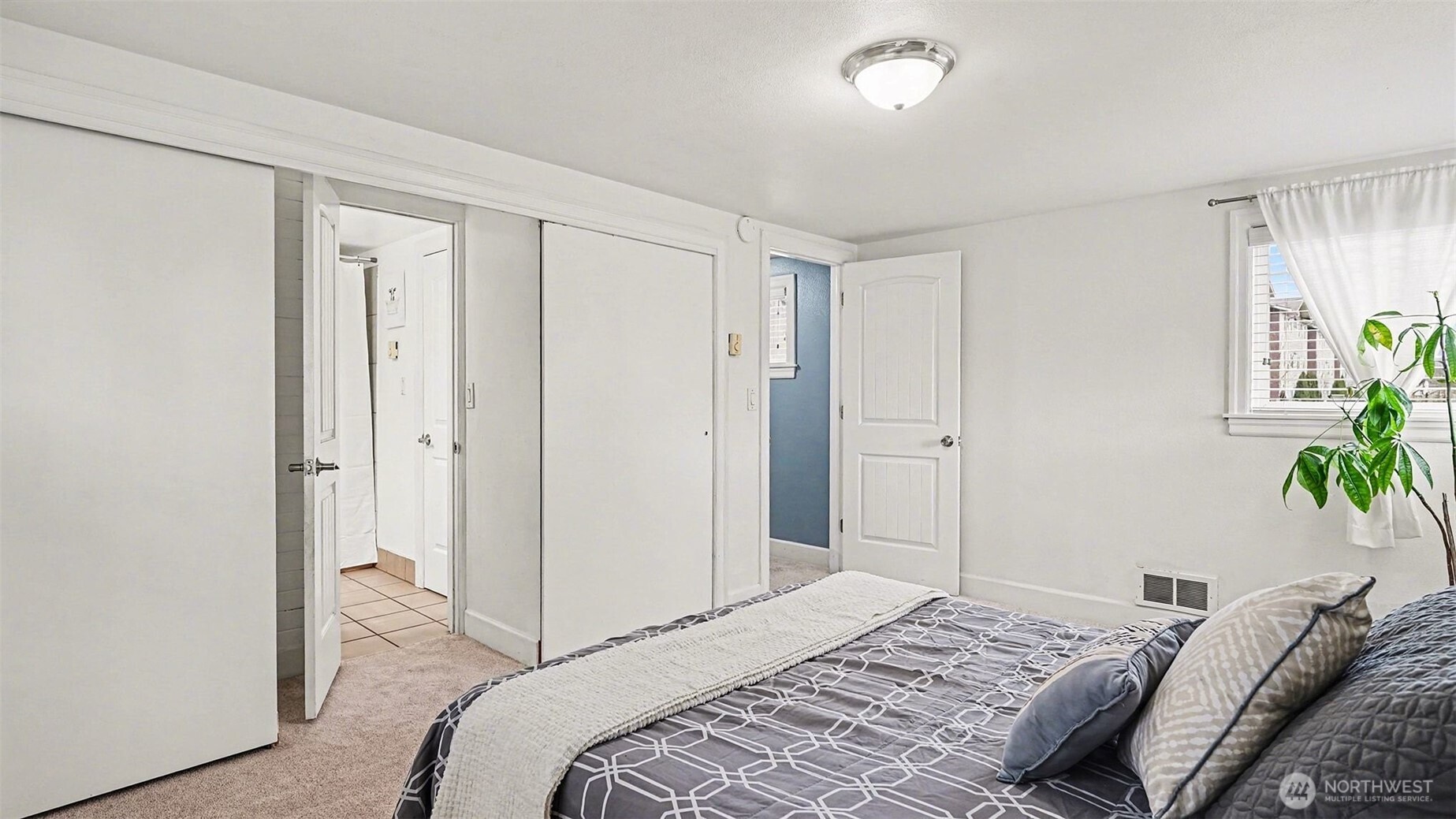 544 Simons Road Monroe, WA 98272 - Photo 16 of 34 a bedroom with a bed and hallway with potted plants