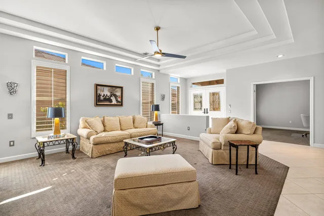 a living room with furniture tv and a flat screen tv
