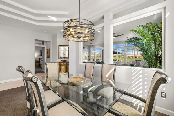 a view of a dining room with furniture wooden floor and chandelier