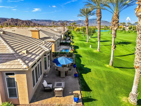 a living room with furniture a large window and a fireplace