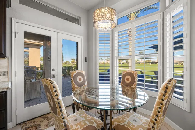 a balcony with furniture and a floor to ceiling window