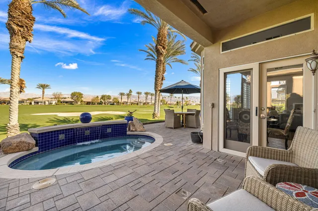 a view of a swimming pool with an outdoor seating