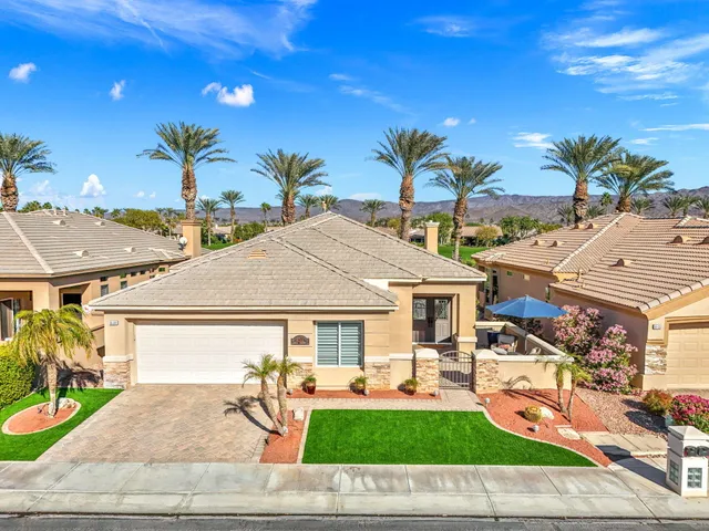 a living room with furniture wooden floor and a kitchen view