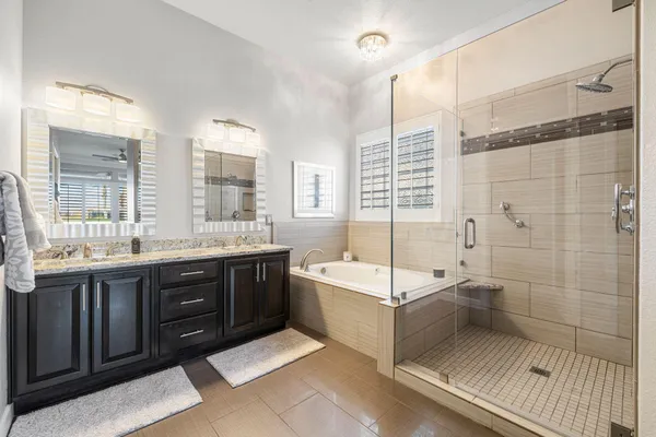 a spacious bedroom with a bed a couch and a large window with the outer view