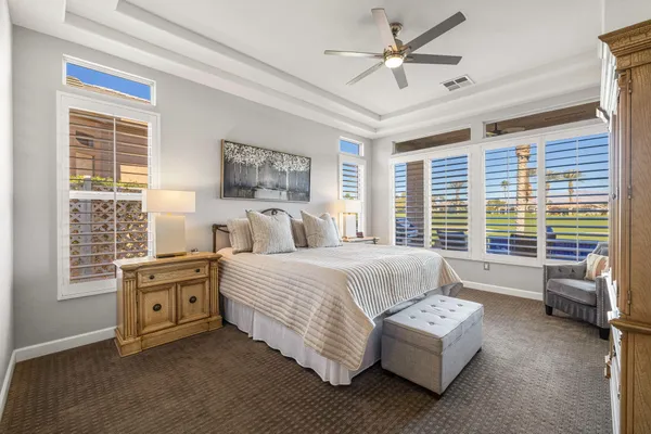 a living room with furniture a ceiling fan and a window