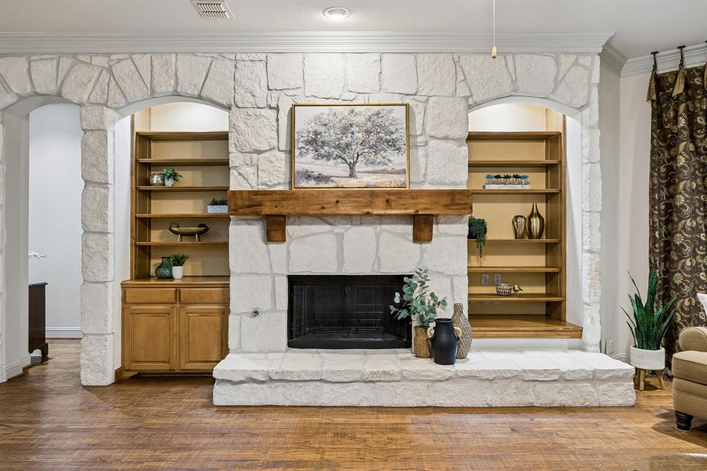 5802 Corinth Chapel Road Parker, TX 75002 - Photo 12 of 40 This beautiful gas, stone fireplace is wood burning and boasts a lovely cedar mantel. The stonework extends to cover the entire wall. Built-in bookshelves add to the charm. The arched opening seen to the left leads to the sleeping quarters.