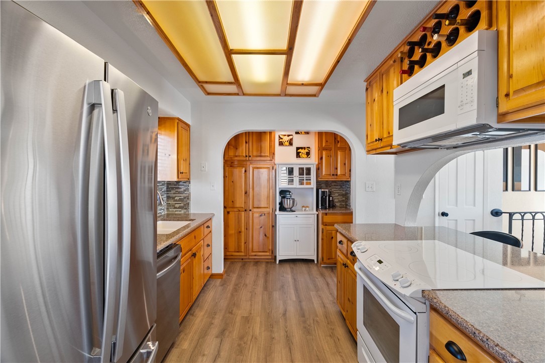3211 Laguna Shores Road Corpus Christi, TX 78418 - Photo 12 of 29 a view of a kitchen with a sink and wooden floor