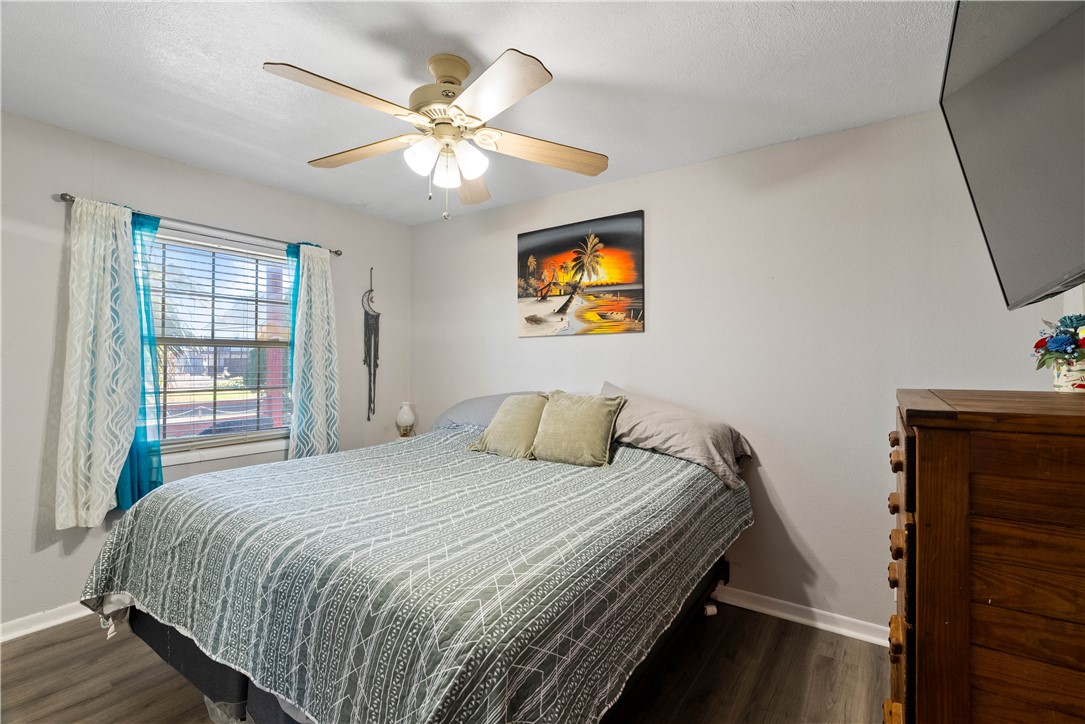 3211 Laguna Shores Road Corpus Christi, TX 78418 - Photo 17 of 29 a bedroom with a bed and a chandelier