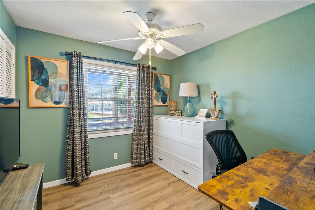 3211 Laguna Shores Road Corpus Christi, TX 78418 - Photo 19 of 29 a bedroom with a bed and a chandelier