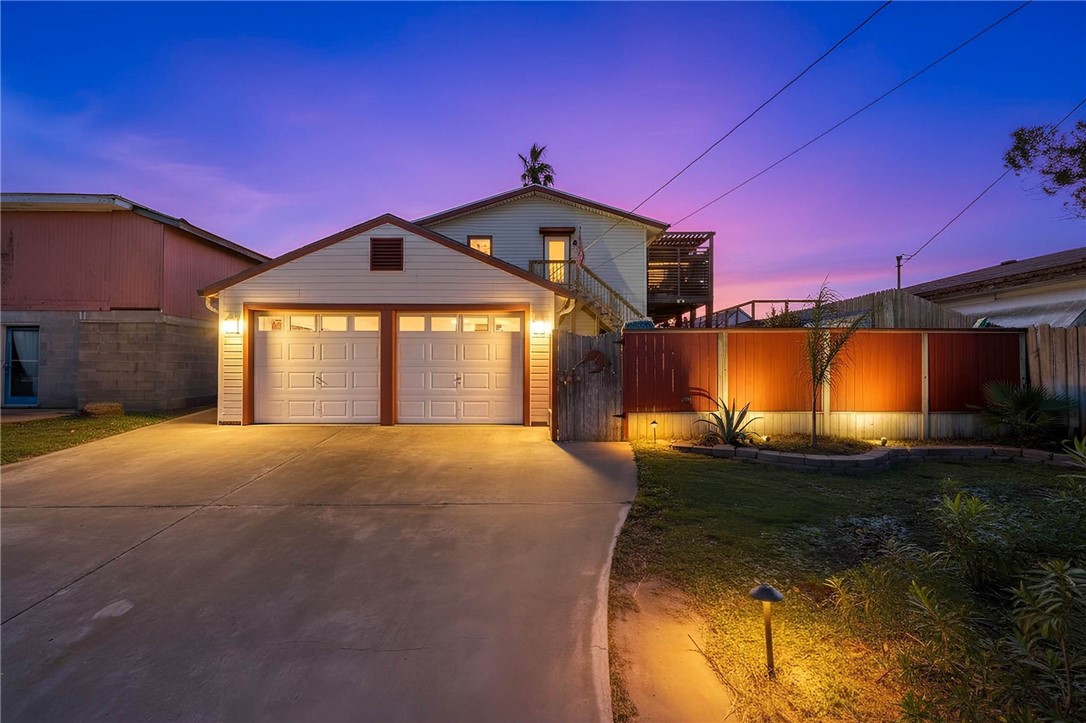 3211 Laguna Shores Road Corpus Christi, TX 78418 - Photo 26 of 29 a front view of a house with a yard