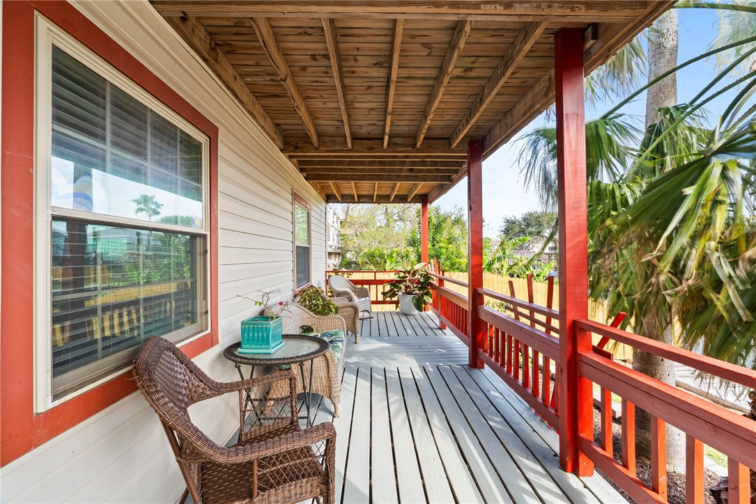 3211 Laguna Shores Road Corpus Christi, TX 78418 - Photo 8 of 29 a view of porch with a table and chairs and wooden floor