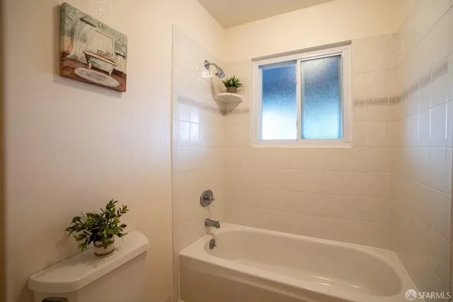 a white bath tub sitting next to a white sink