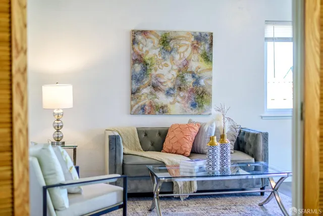 a living room with furniture and a painting