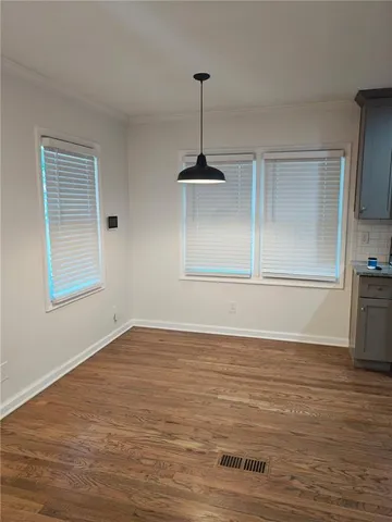 a view of a room with wooden floor cabinets and a window