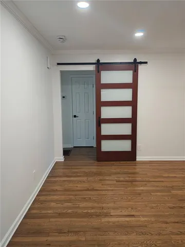 a view of a room with wooden floor