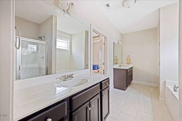 a bathroom with a sink a mirror and a bathtub