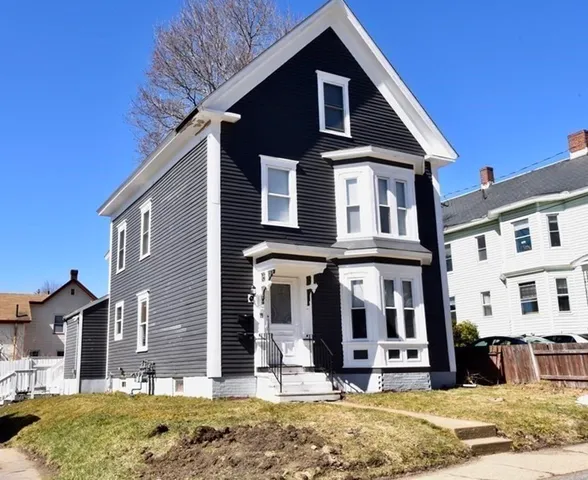 a front view of a house with a yard