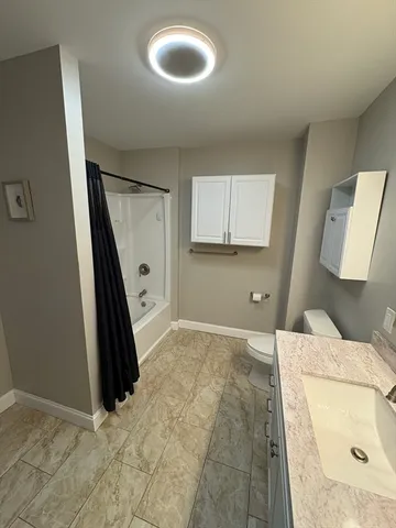 a bedroom with a bed and a large mirror