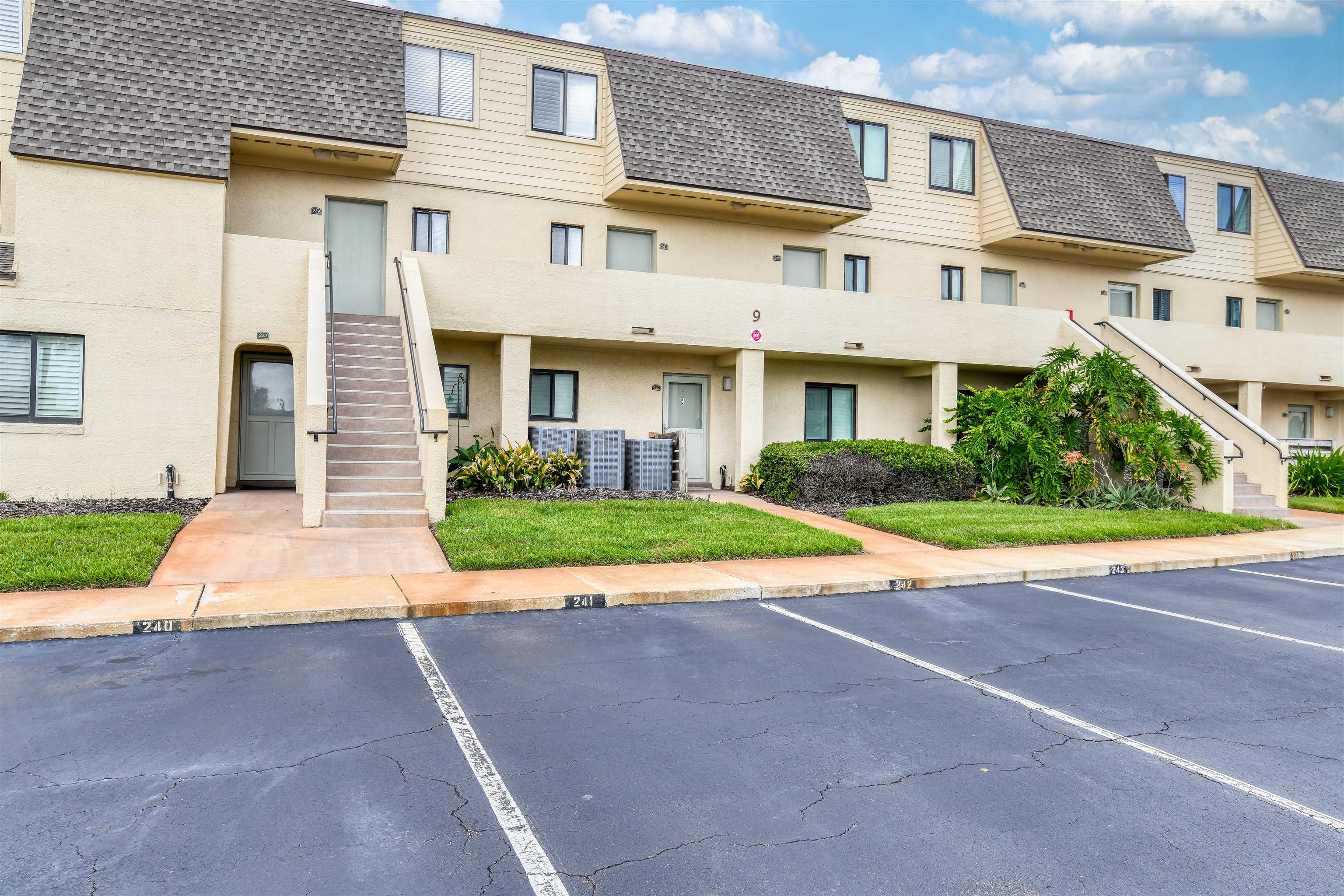 8550 A1A South, Unit 241 St. Augustine, FL 32080 - Photo 2 of 38 a front view of a house with a yard and garage