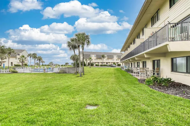 a view of an house with backyard porch and garden