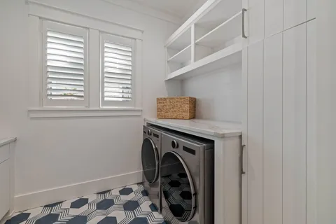 a kitchen with stainless steel appliances granite countertop a stove top oven a dining table and chairs with wooden floor