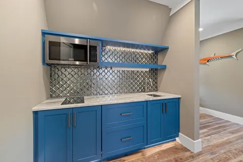 a room with pool table and windows