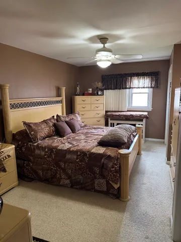 a spacious bedroom with a bed and window