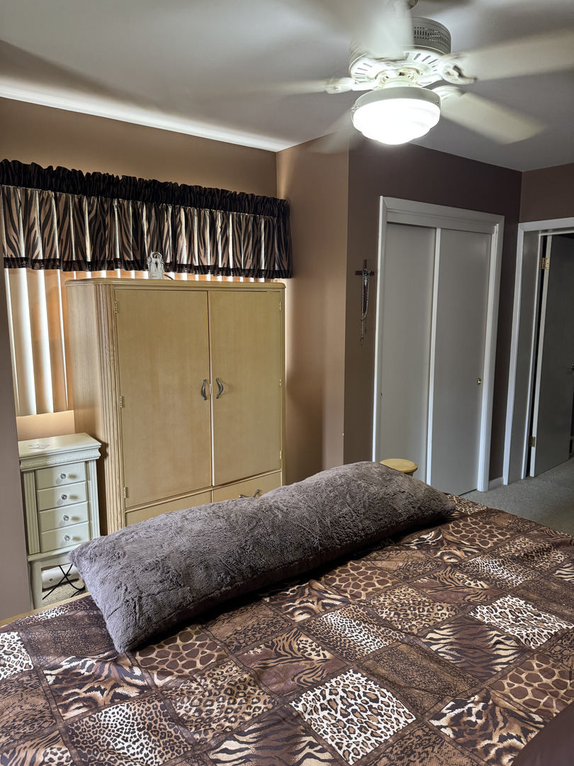 2527 Keystone Avenue North Riverside, IL 60546 - Photo 15 of 33 a bedroom with a bed and a chandelier