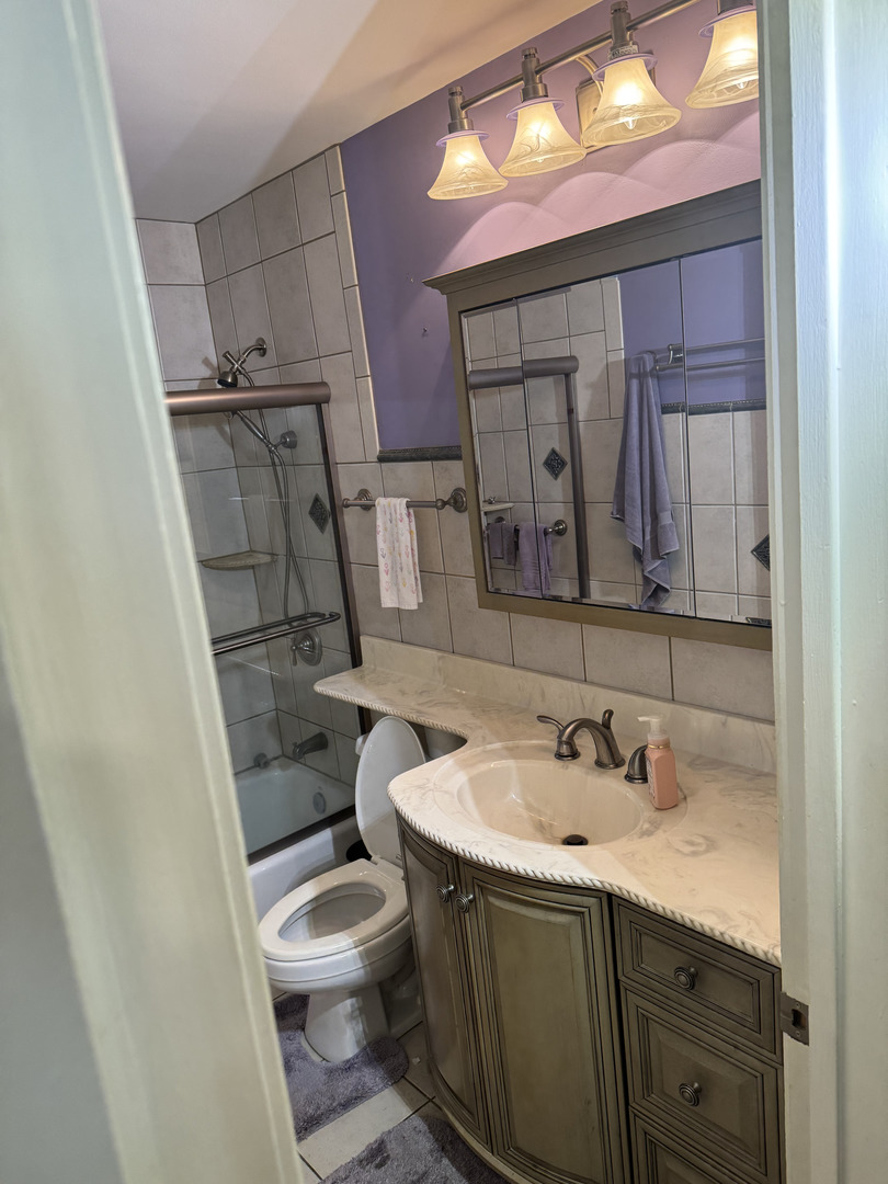 2527 Keystone Avenue North Riverside, IL 60546 - Photo 19 of 33 a bathroom with a sink a toilet and a mirror