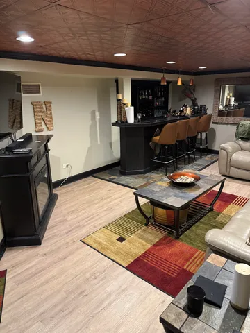 a dining room with furniture and a floor to ceiling window
