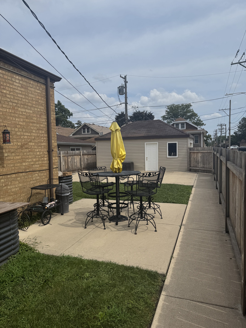 2527 Keystone Avenue North Riverside, IL 60546 - Photo 33 of 33 a view of a patio with table and chairs potted plants with wooden floor