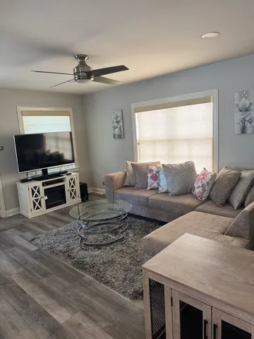 a living room with furniture and a flat screen tv